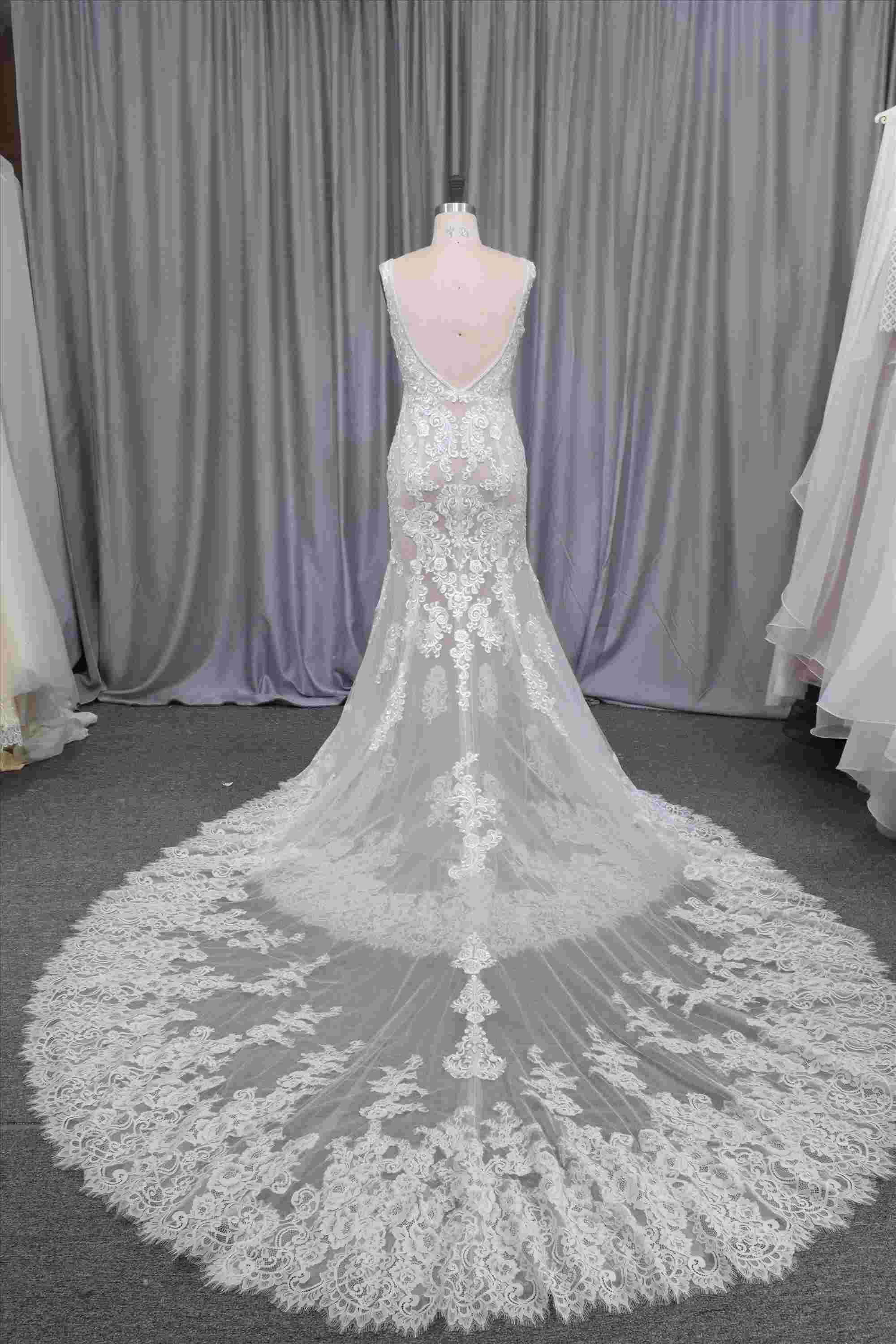 Gorgeous nude color lace mermaid gown with a beautiful train bridal dress