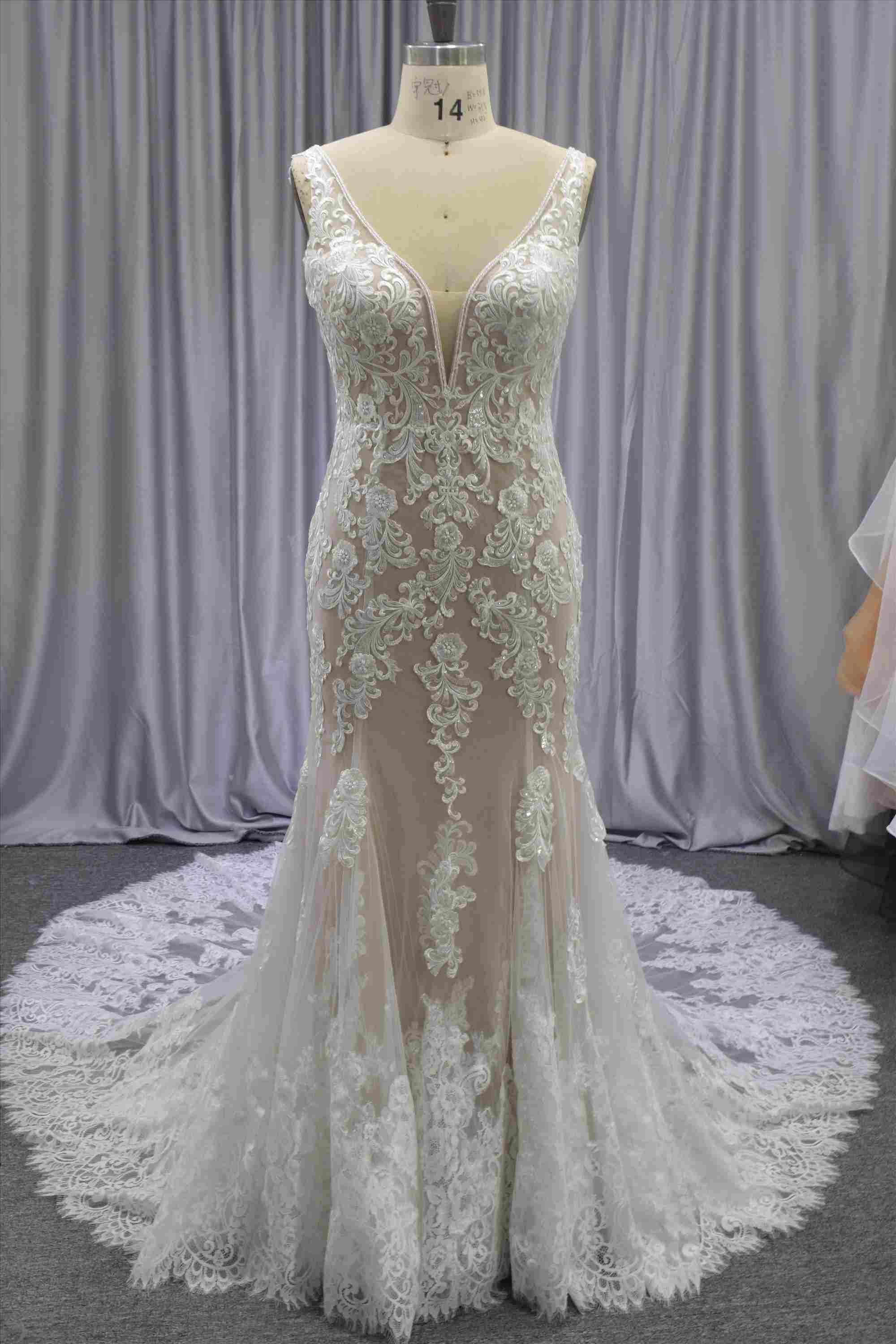 Gorgeous nude color lace mermaid gown with a beautiful train bridal dress