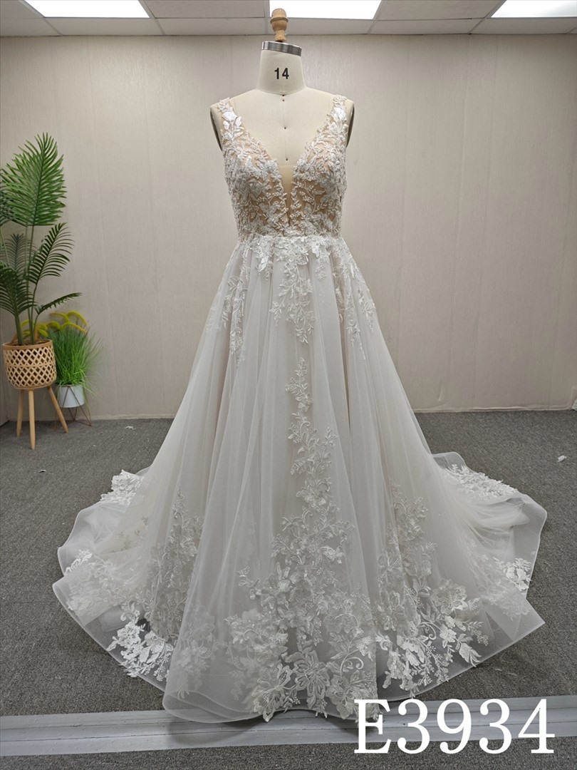 A-line wedding evening gown with a V-neck, straps, appliqués, beads