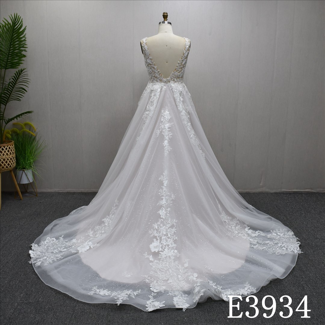 A-line wedding evening gown with a V-neck, straps, appliqués, beads