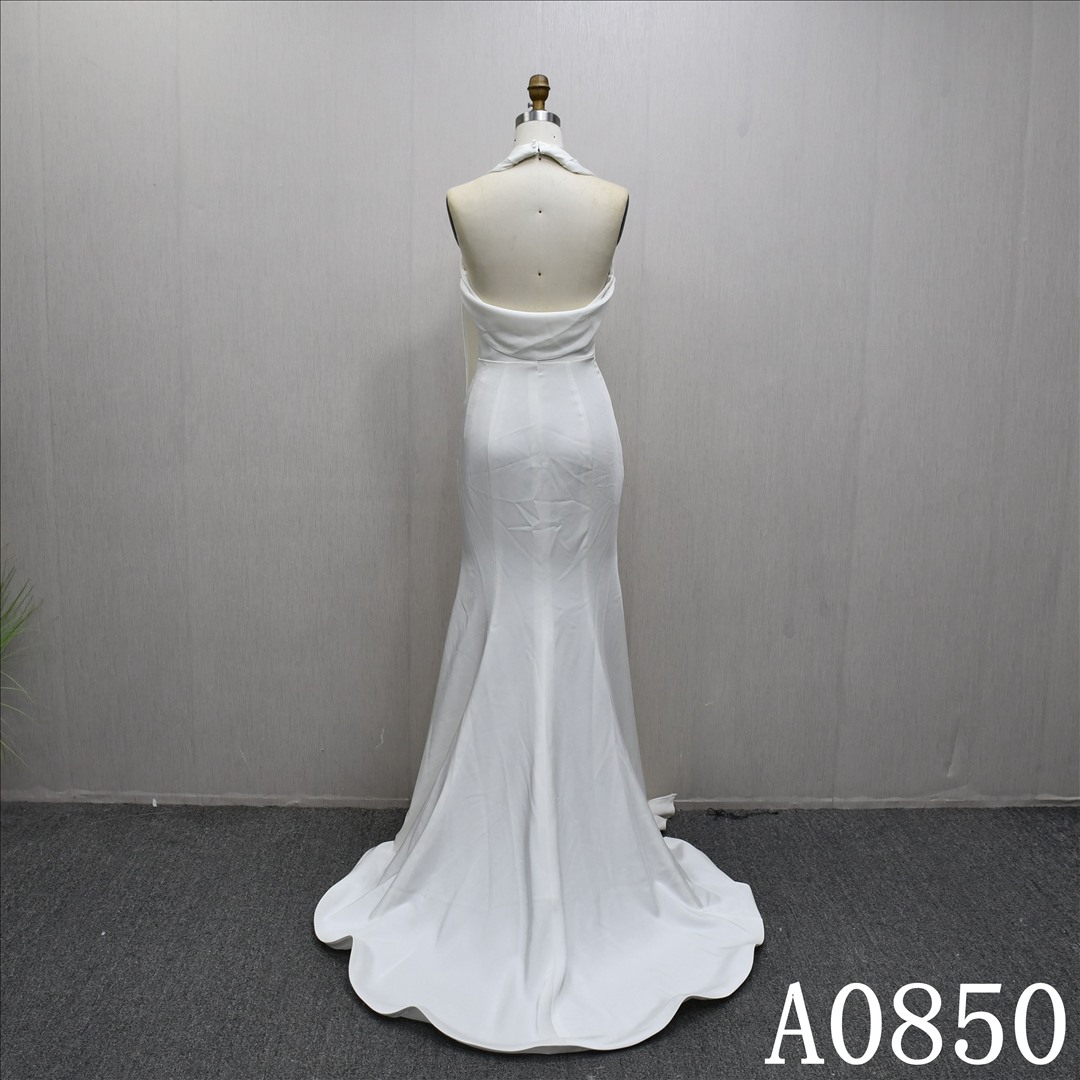 Elegant halter neck mermaid evening gown with a plunging backless neckline.