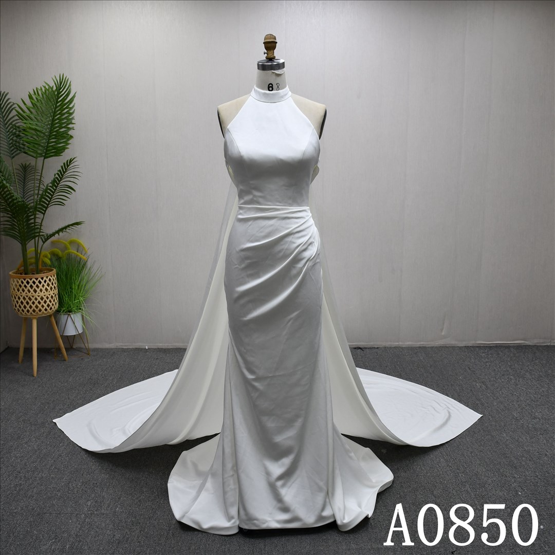 Elegant halter neck mermaid evening gown with a plunging backless neckline.