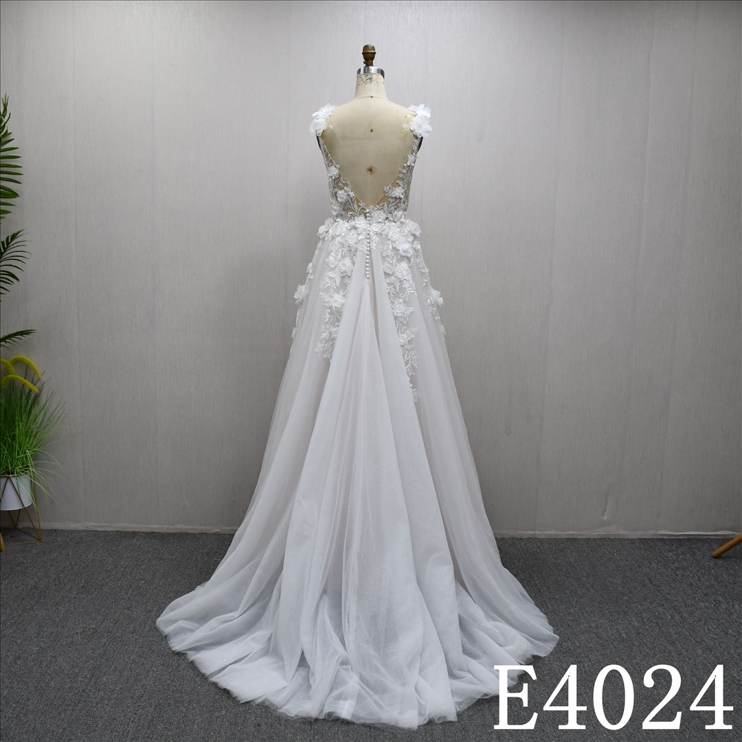 An A-line wedding dress with a luxurious lace design and a zipper and buttons at the back.