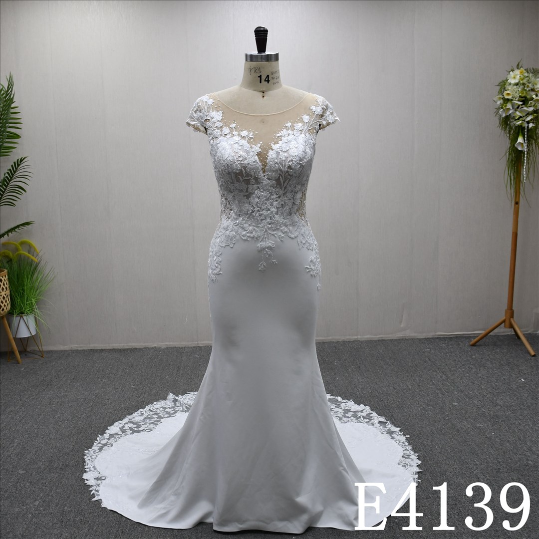 This bestselling Mermaid dress features a unique design, lace detailing, and a detachable train.