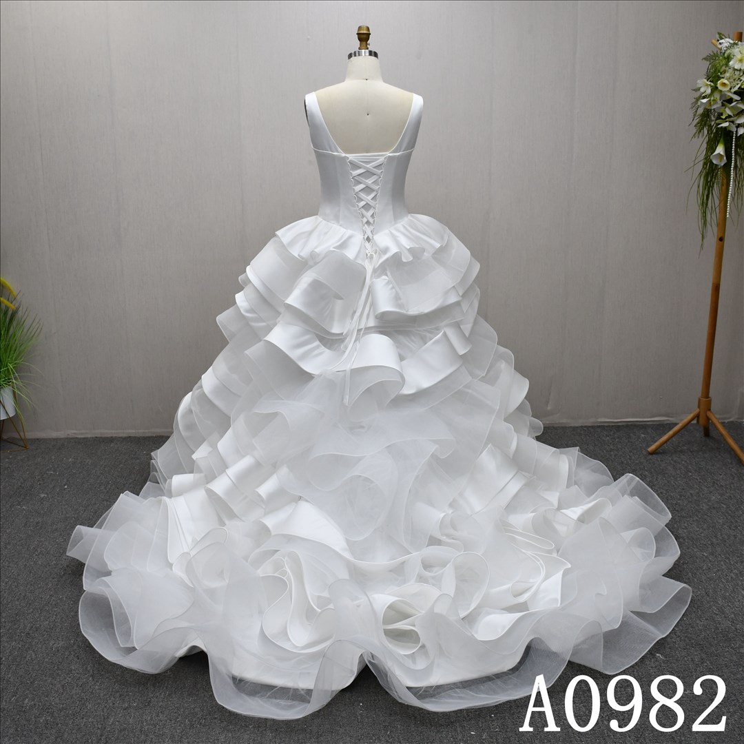 A gorgeous and unique A-line wedding dress/evening gown with a ruffled hem design.