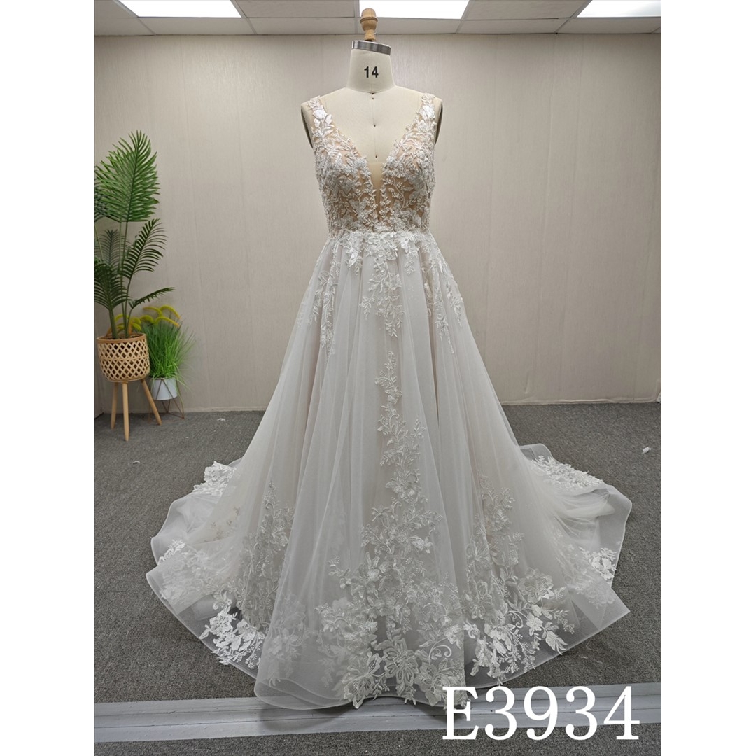A-line wedding evening gown with a V-neck, straps, appliqués, beads