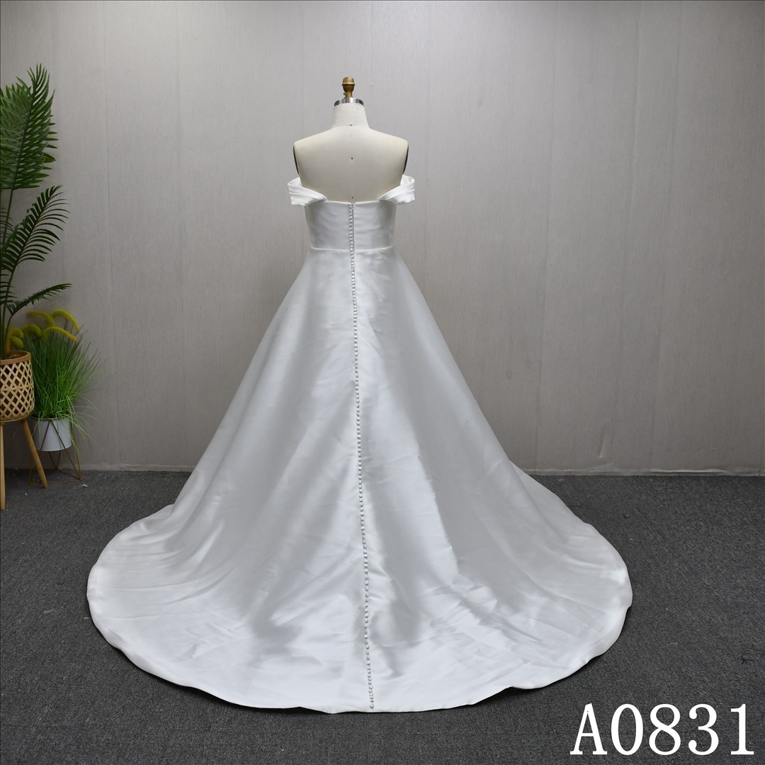A-line wedding dress with Off sleeves and a simple design  dress features a front slit.