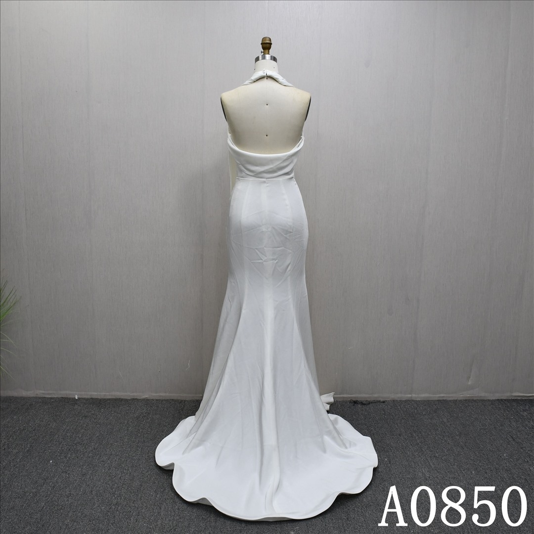 Elegant halter neck mermaid evening gown with a plunging backless neckline.