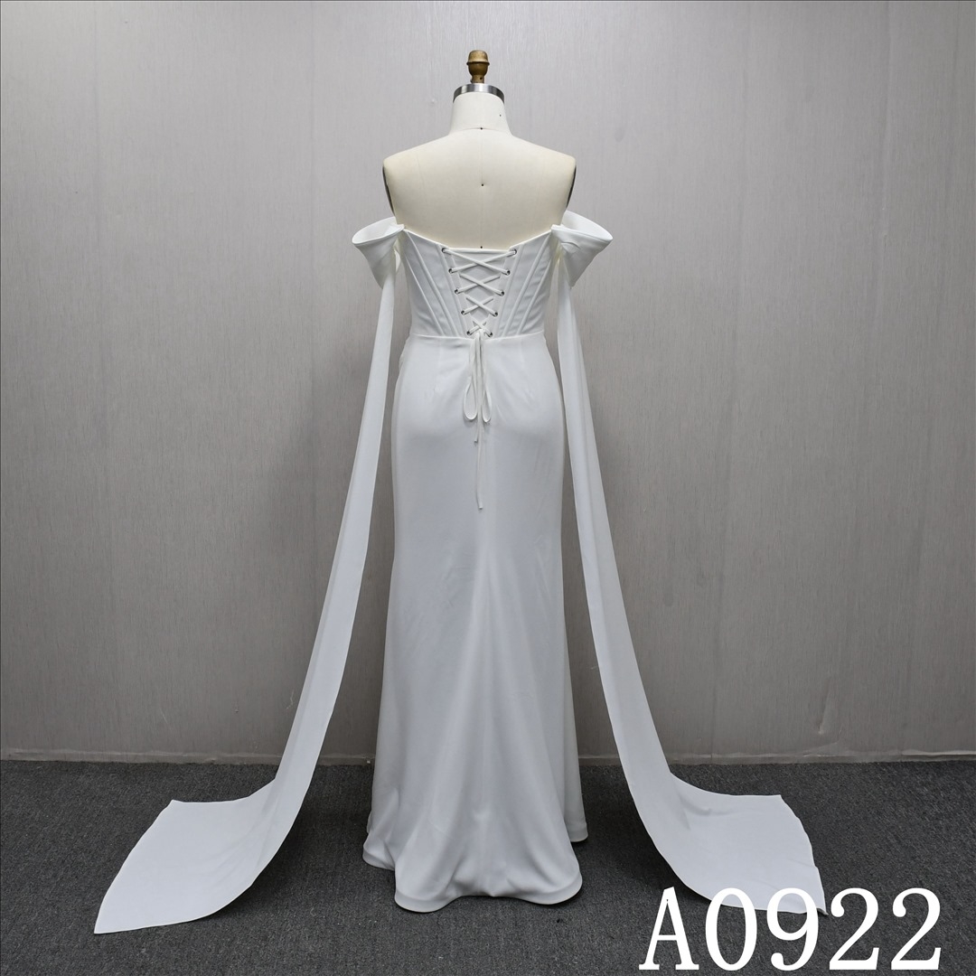 Mermaid wedding dress with off-the-shoulder sleeves, minimalist design and pleated detailing