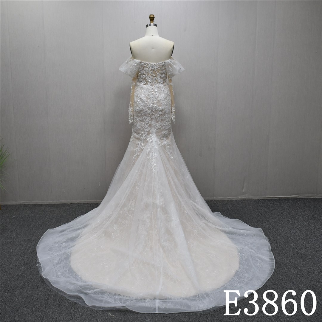 Off-the-shoulder long-sleeved mermaid wedding dress with a unique design of lace and sequins