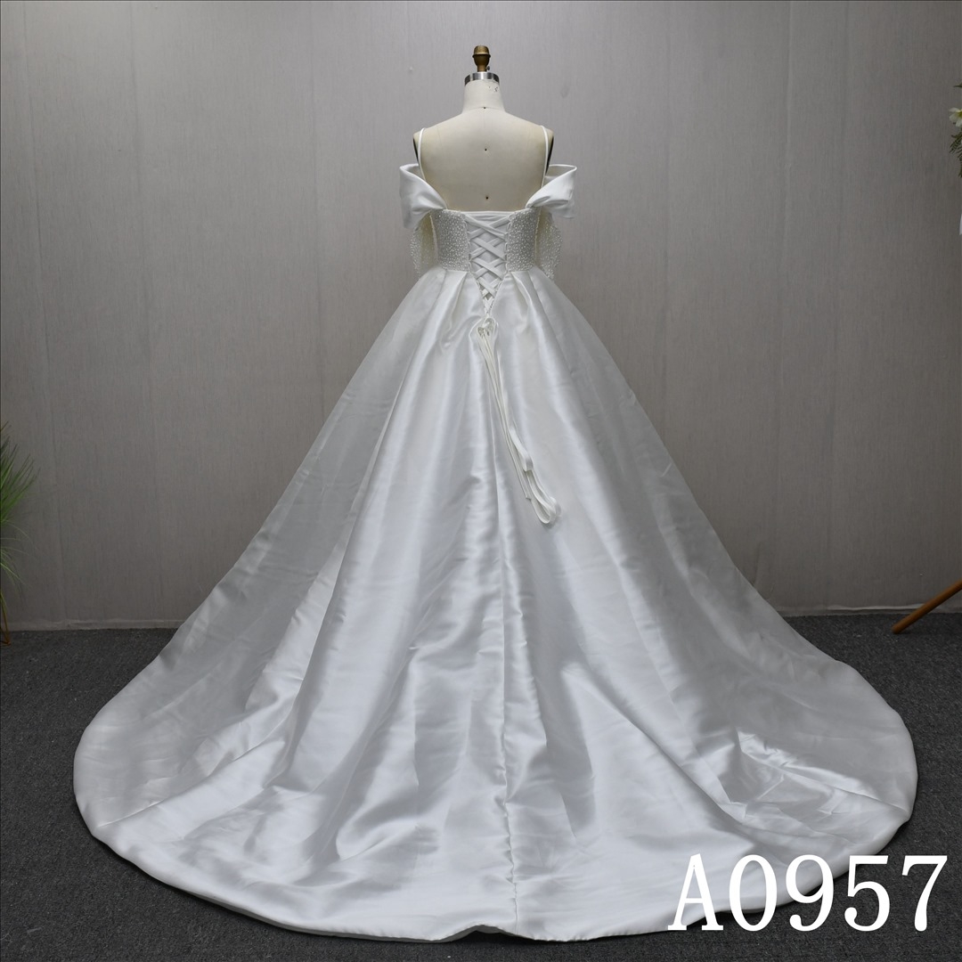 A beautiful A-line, luxurious wedding evening gown with a full pearl bodice and a high slit