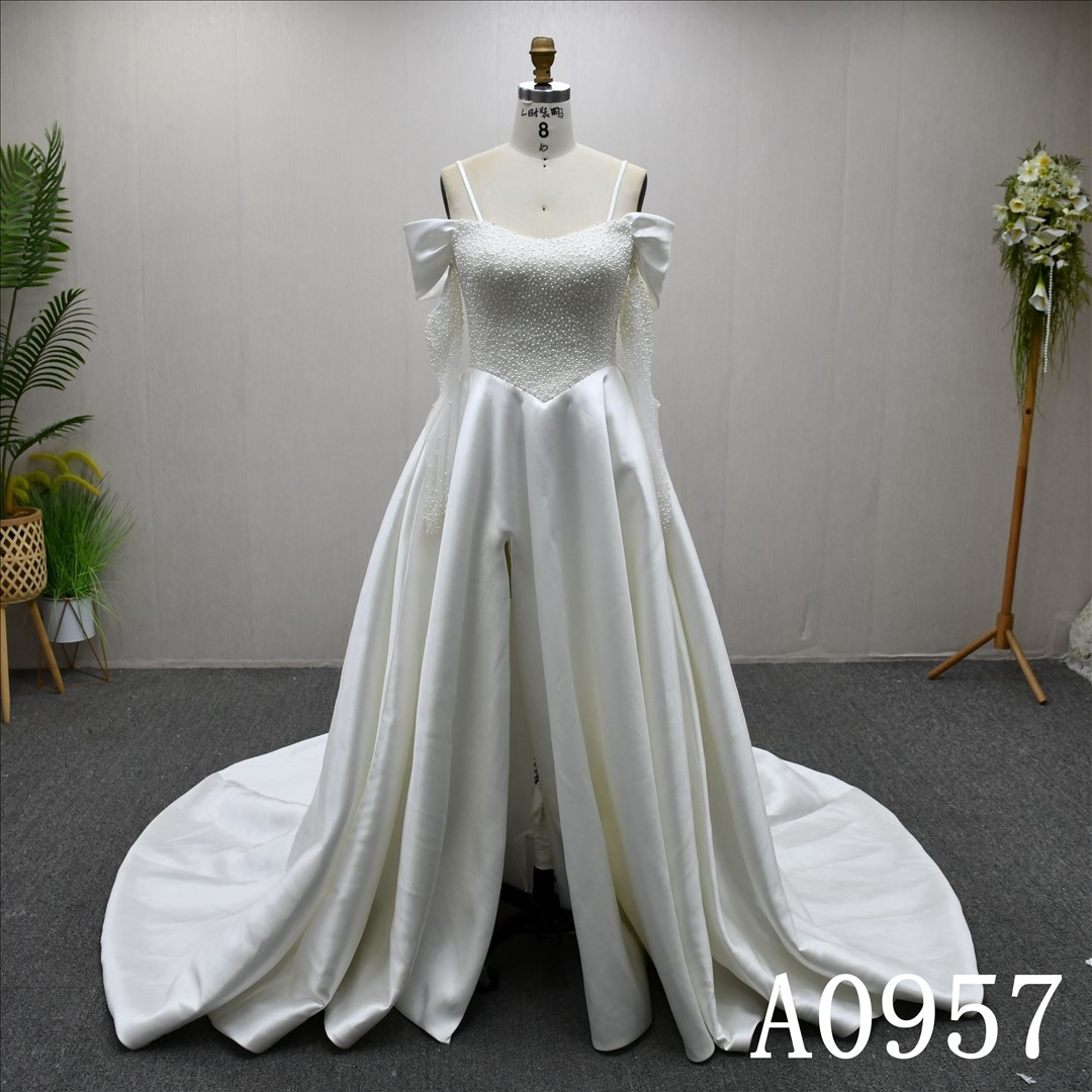 A beautiful A-line, luxurious wedding evening gown with a full pearl bodice and a high slit