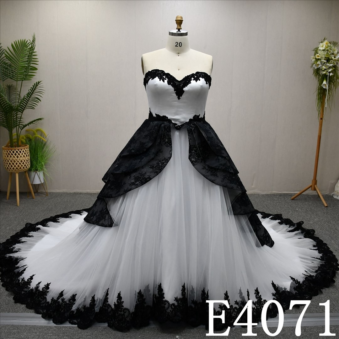 A unique A-line wedding dress in black and white, with a sweetheart neckline and intricate design