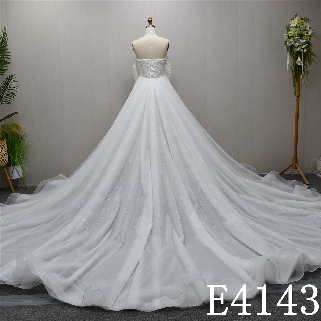 Unique and luxurious design, V-neck, pearl-embellished wedding dress with a detachable train
