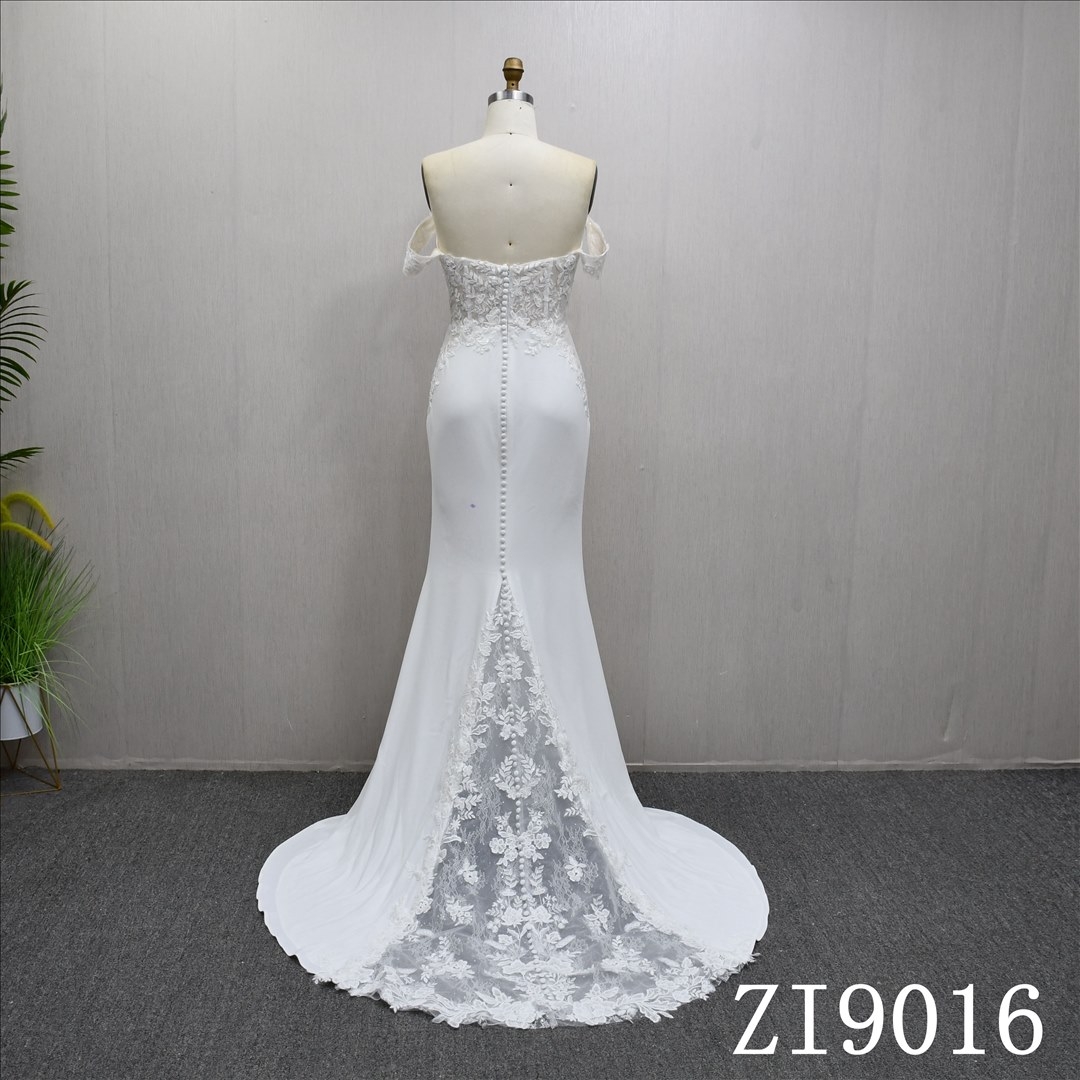 A beautiful Mermaid wedding evening gown with a simple design and lace embellishments.