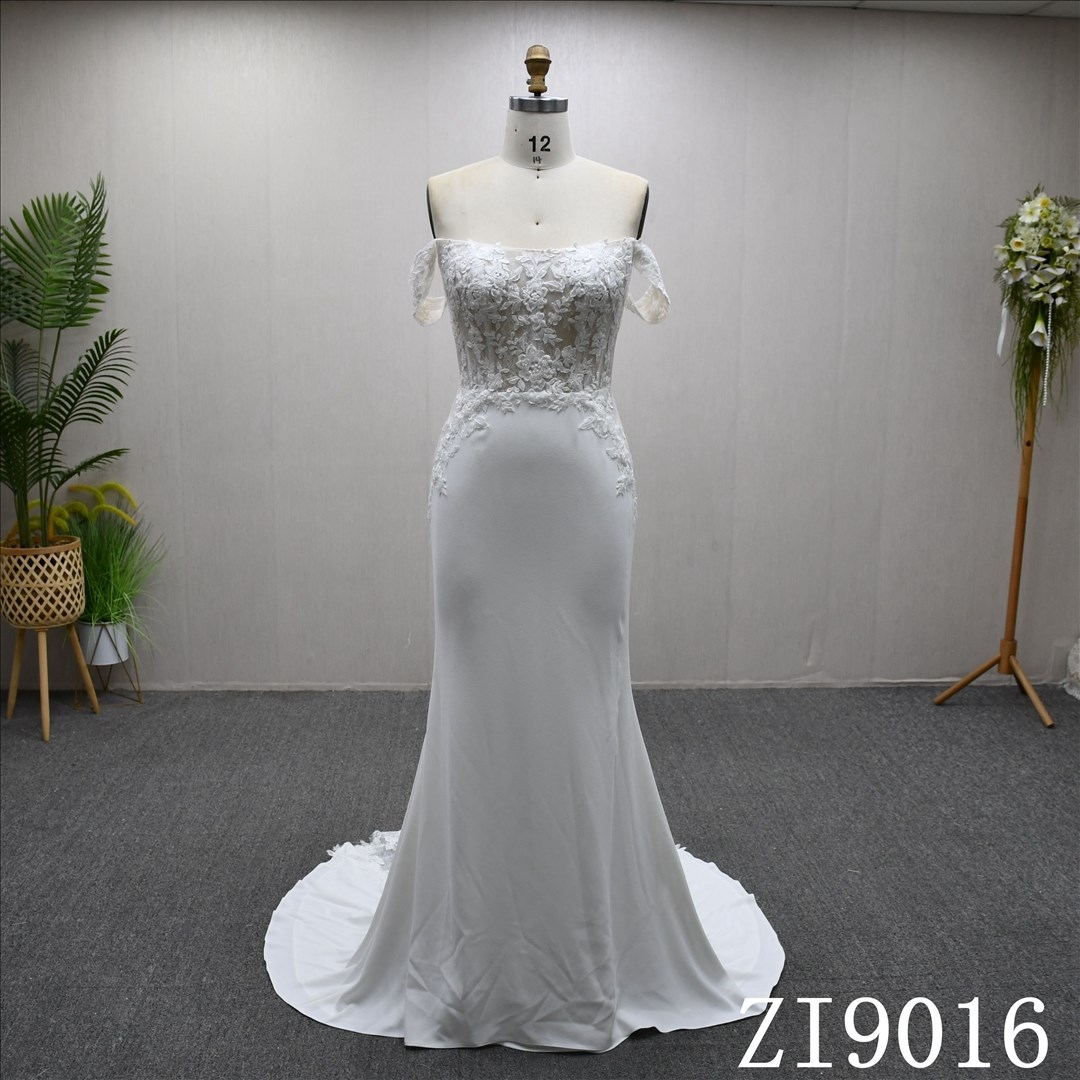 A beautiful Mermaid wedding evening gown with a simple design and lace embellishments.