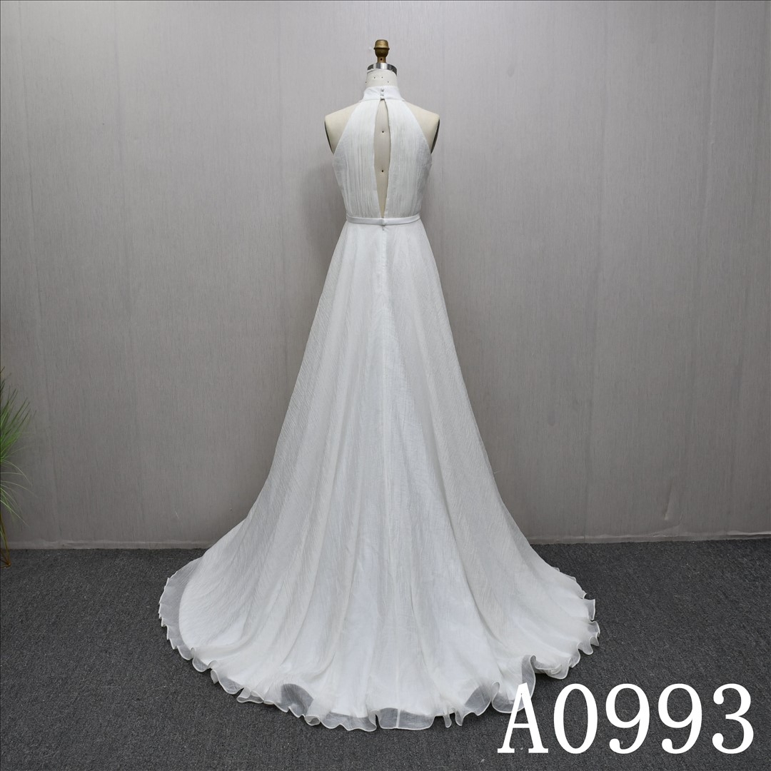 An A-line ivory wedding dress with a simple yet unique design and lace up back.