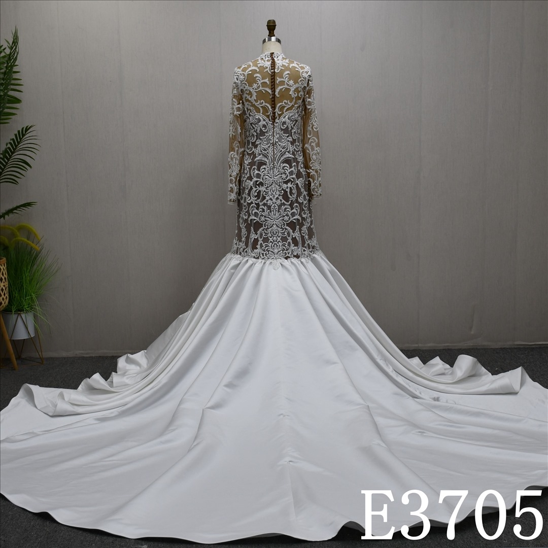 A luxurious mermaid wedding evening gown with a lace and ruffled hem