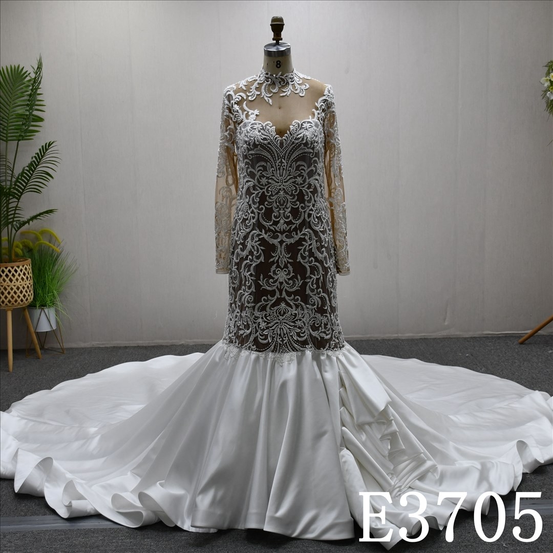 A luxurious mermaid wedding evening gown with a lace and ruffled hem