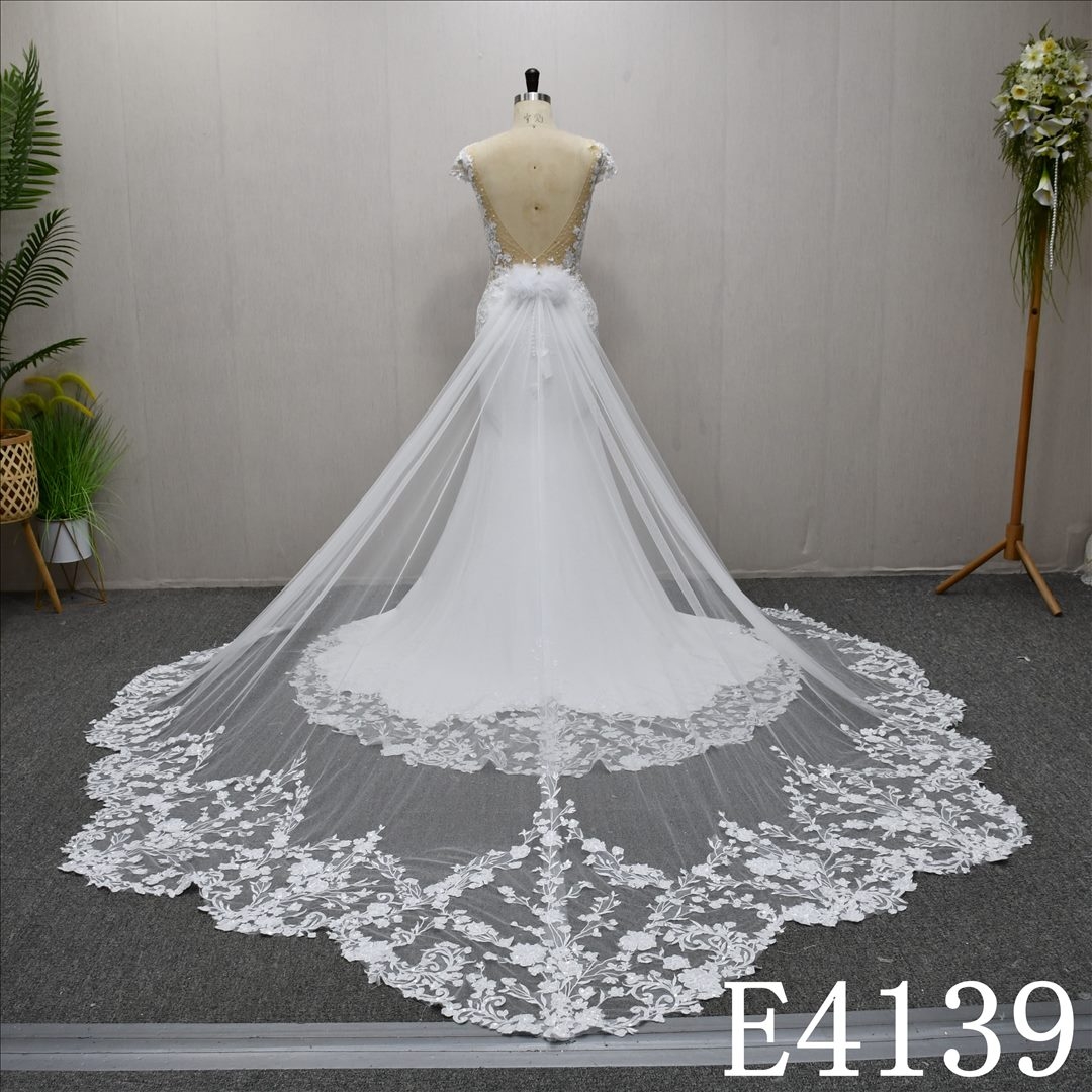 This bestselling Mermaid dress features a unique design, lace detailing, and a detachable train.