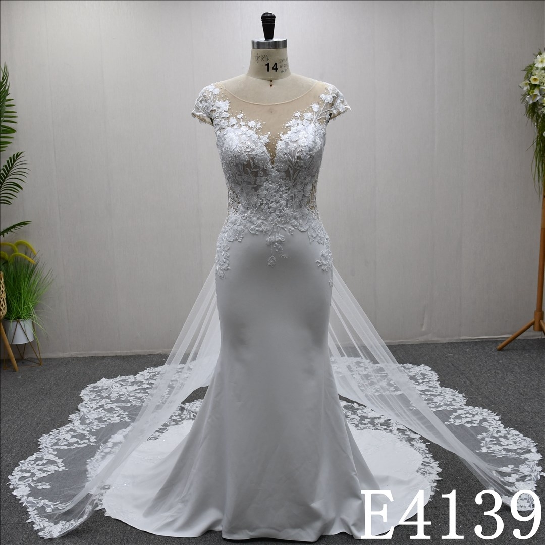 This bestselling Mermaid dress features a unique design, lace detailing, and a detachable train.