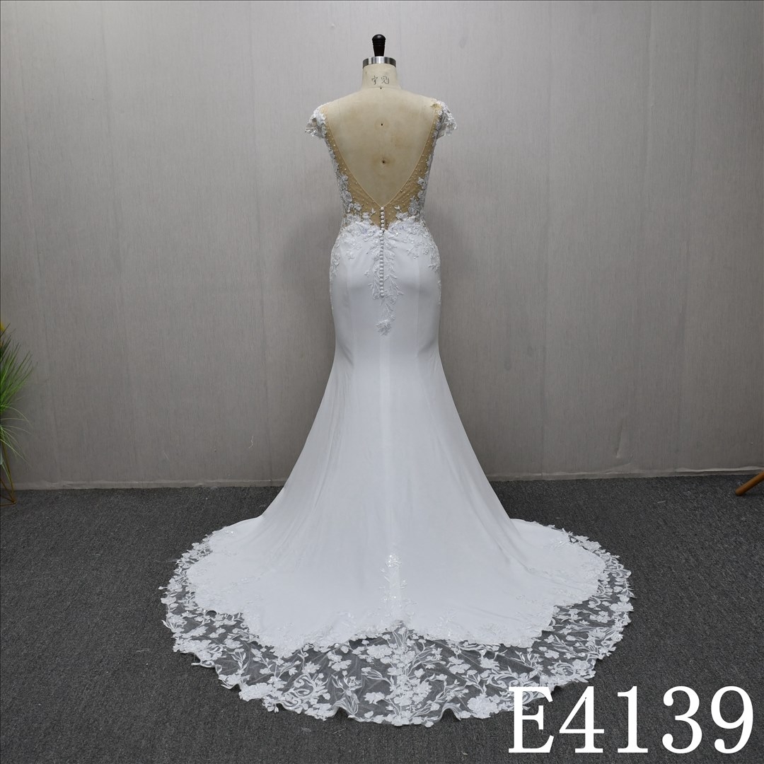 This bestselling Mermaid dress features a unique design, lace detailing, and a detachable train.