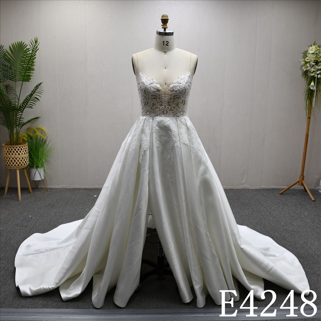 Beautiful and unique A-line lace spaghetti strap wedding dress with a front slit.