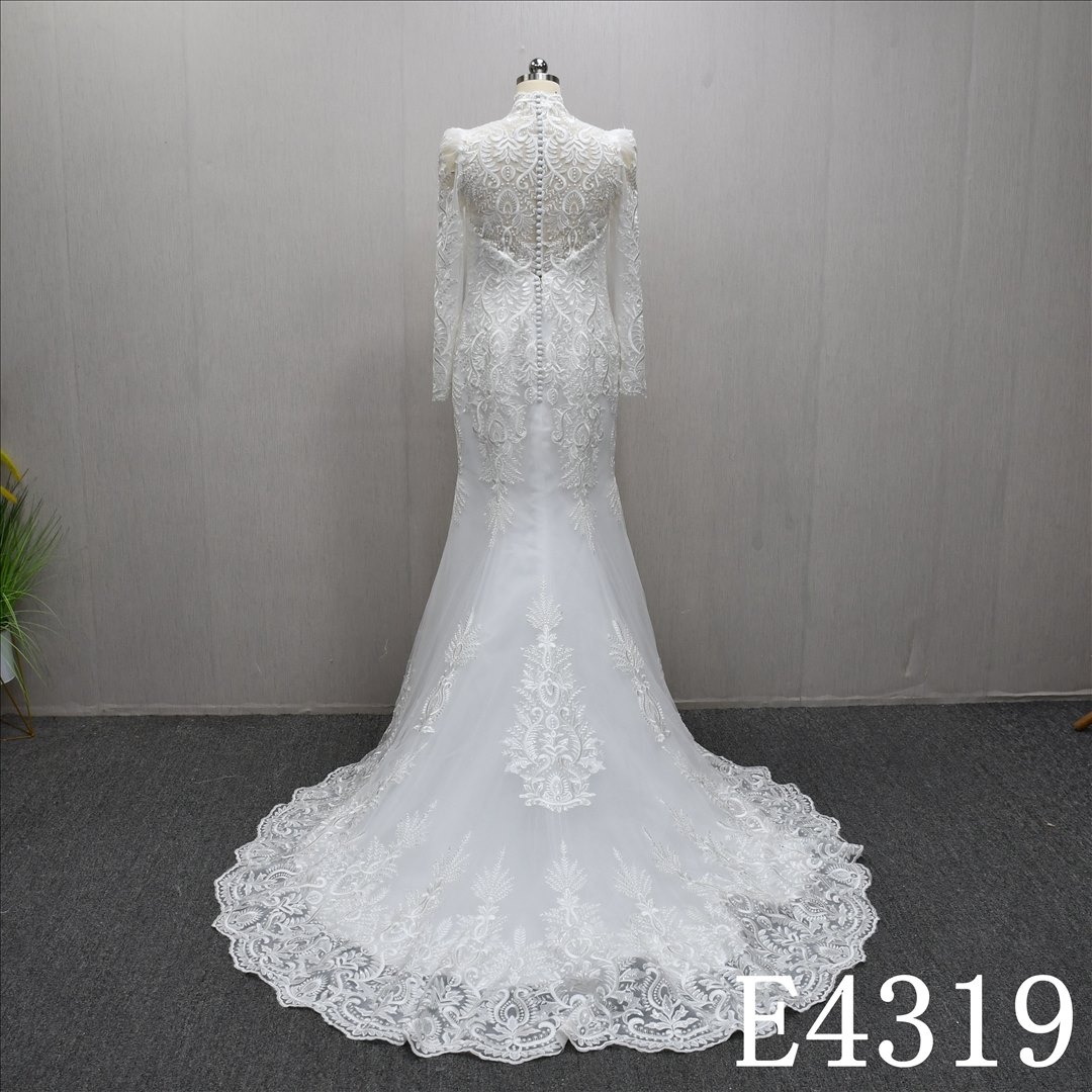 Mermaid wedding gown with a unique V-neckline and full-body lace embellishments