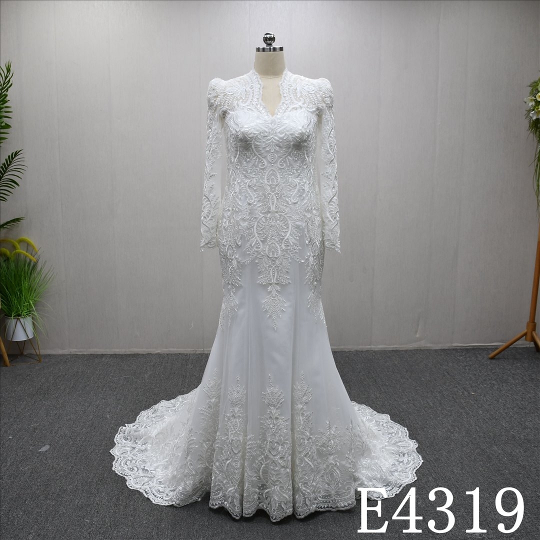 Mermaid wedding gown with a unique V-neckline and full-body lace embellishments
