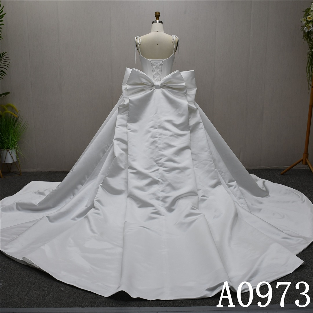 A beautiful A-line wedding evening gown with a simple pleats design with big bow