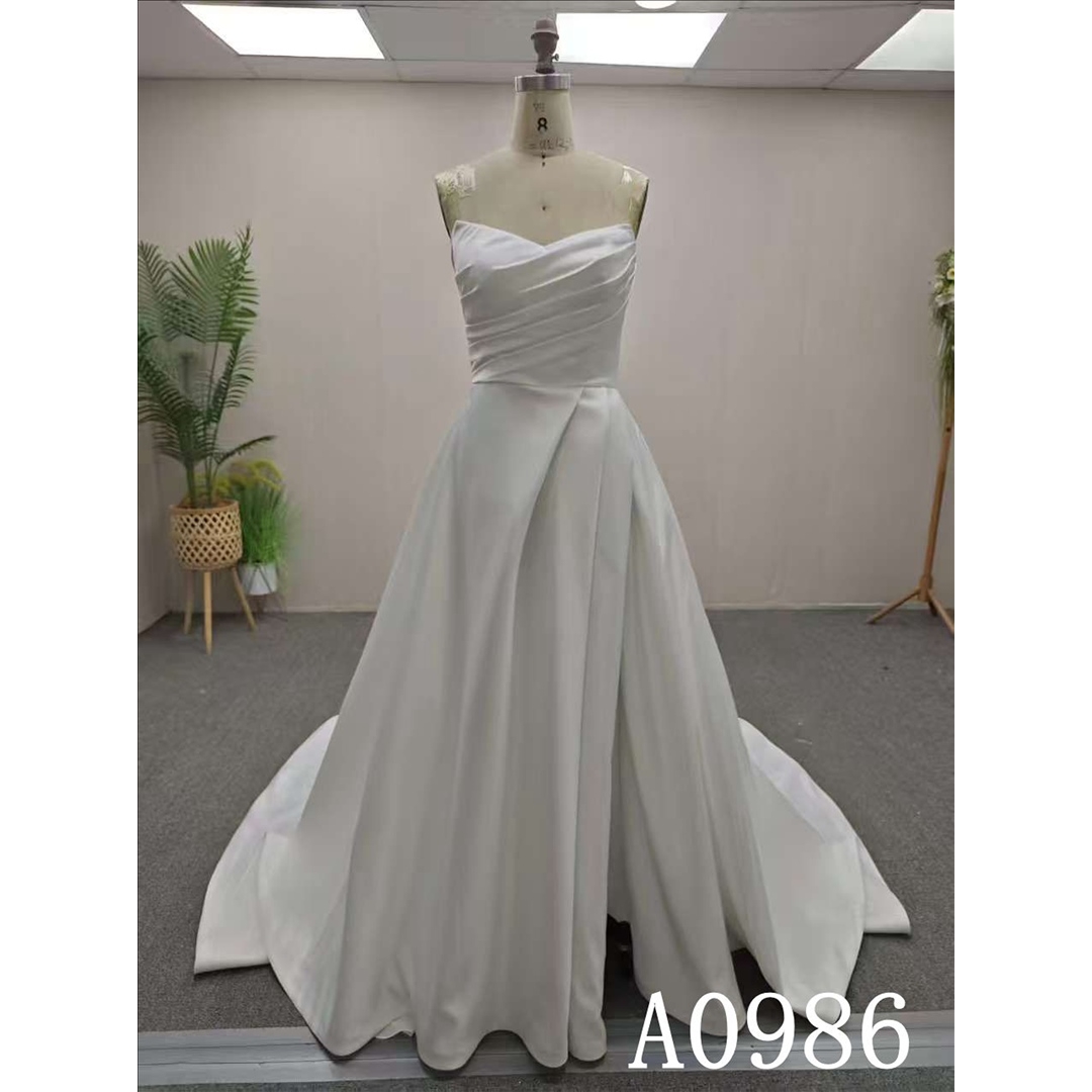 An A-line ivory wedding dress with a simple yet unique design and back zipper and button.