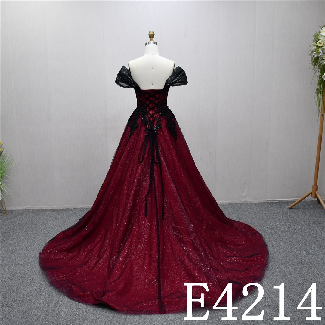 A unique A-line wedding dress in red and black, with a sweetheart neckline and intricate design
