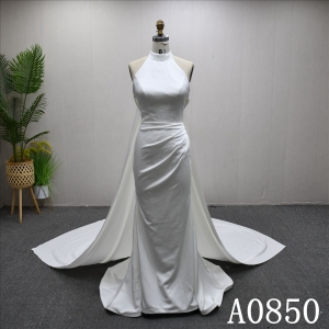 Elegant halter neck mermaid evening gown with a plunging backless neckline.