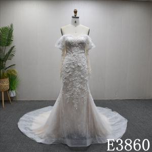 Off-the-shoulder long-sleeved mermaid wedding dress with a unique design of lace and sequins