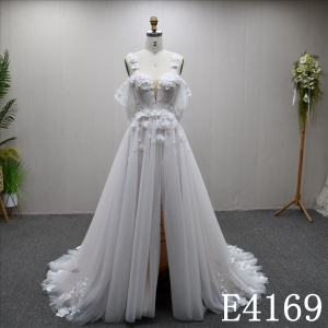 A-line ivory and nude wedding gown with unique design, adorned with Lace flower