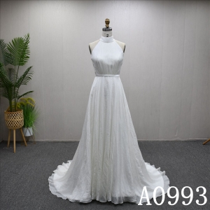 An A-line ivory wedding dress with a simple yet unique design and lace up back.