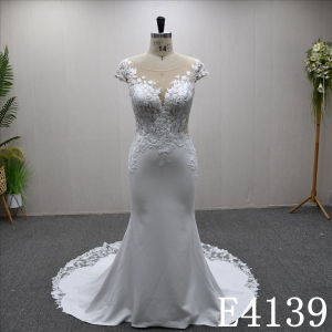 This bestselling Mermaid dress features a unique design, lace detailing, and a detachable train.