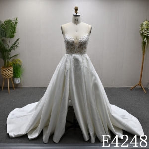 Beautiful and unique A-line lace spaghetti strap wedding dress with a front slit.