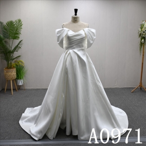 An A-line wedding dress with a Simple design and a zipper and buttons at the back.