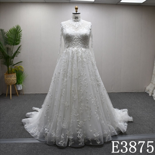 A-line wedding dress with high neck, long sleeves, appliqués, beads, and sequins