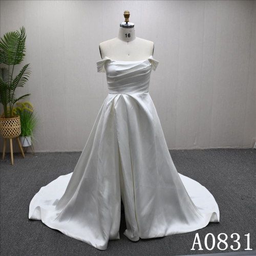 A-line wedding dress with Off sleeves and a simple design  dress features a front slit.