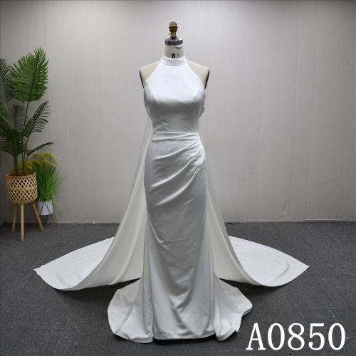 Elegant halter neck mermaid evening gown with a plunging backless neckline.