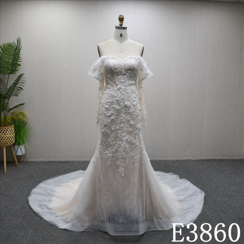 Off-the-shoulder long-sleeved mermaid wedding dress with a unique design of lace and sequins