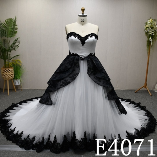 A unique A-line wedding dress in black and white, with a sweetheart neckline and intricate design