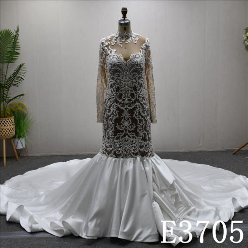 A luxurious mermaid wedding evening gown with a lace and ruffled hem