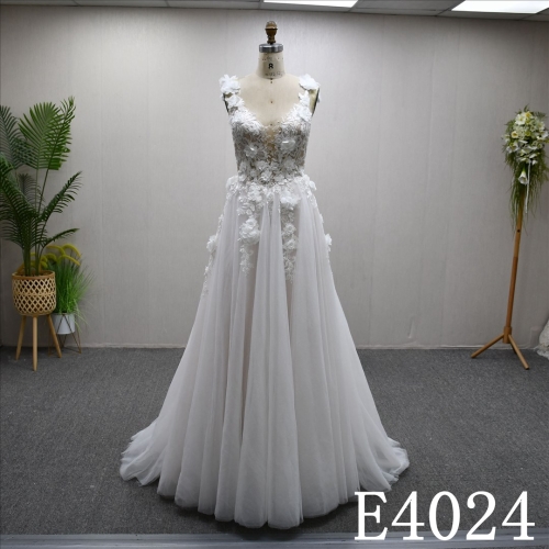 An A-line wedding dress with a luxurious lace design and a zipper and buttons at the back.