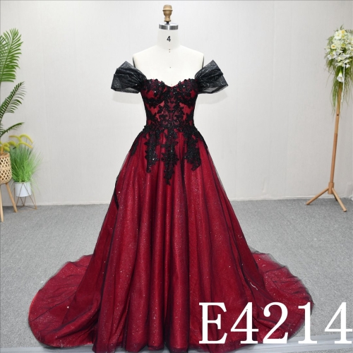 A unique A-line wedding dress in red and black, with a sweetheart neckline and intricate design